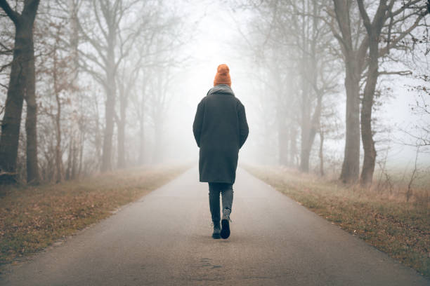 istock A woman walking into the distance 1198204924