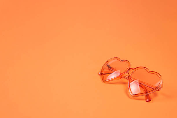 istock Summer hat lay on pink hair on orange background. 1198205508