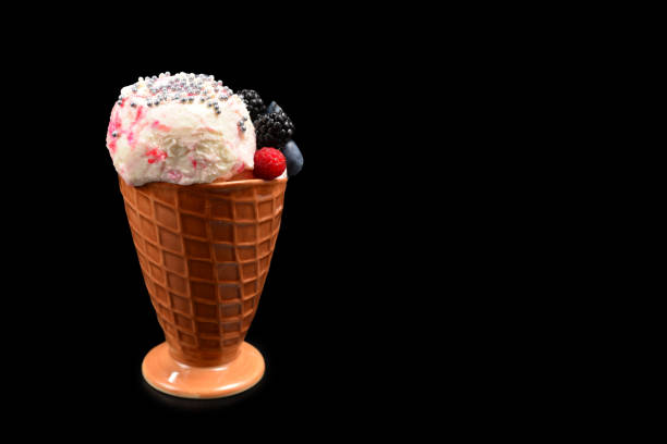 istock Ice cream with blueberries, blackberries and raspberries on a black background.  Copy space. 1198205515
