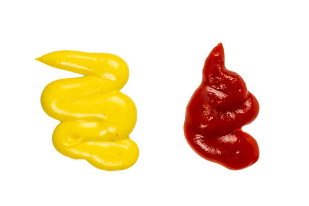 istock Ketchup and yellow sauce splashes isolated on white background 1198207645