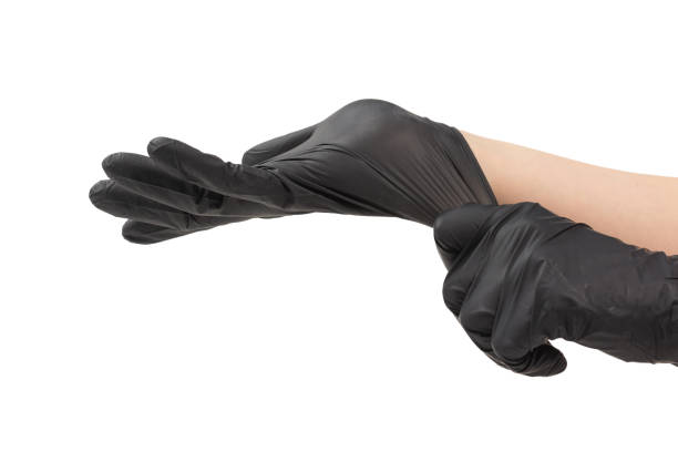 istock Woman puts on black rubber gloves. 1198208258