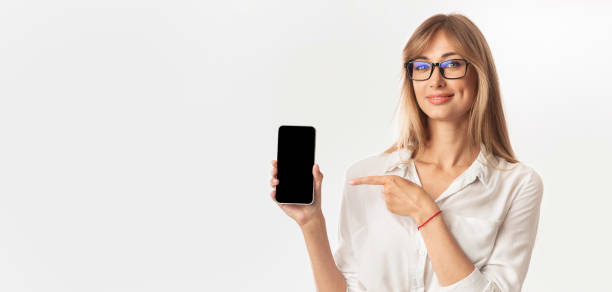 istock Lady Holding Phone Pointing Finger At Screen, White Background, Mockup 1198210898