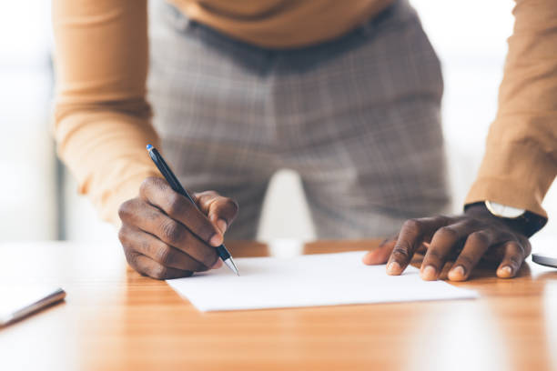 istock Closeup of afro manager concluding official contract 1198211042