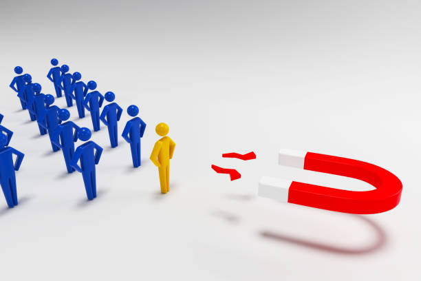 istock Close-up attracting blue Human Figures With Horseshoe Magnet On blue Background. 3D rendering 1198211617