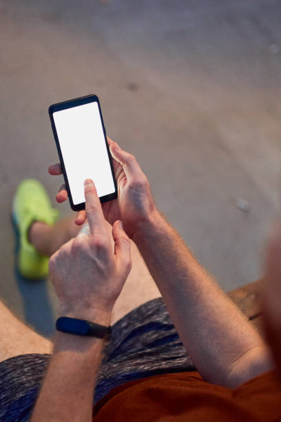 istock Man using cellphone in urban park at night. 1198212819