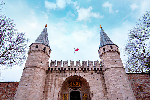 The main Entrance, Gates with Towers and Turkish Flag to Topkapi Palace in Istanbul  in Turkey