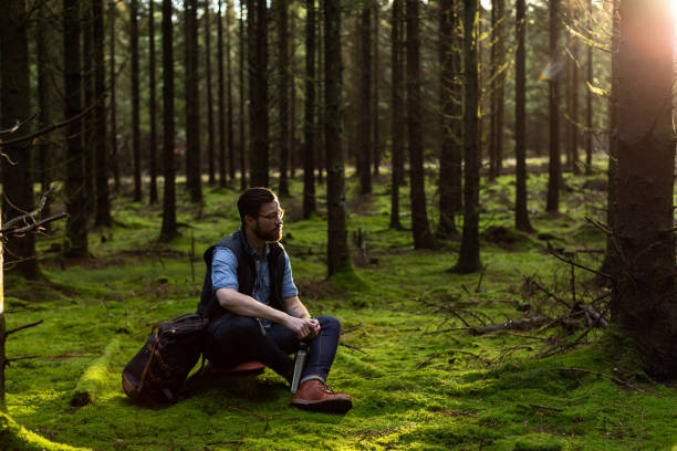 Photo of Man sitting in forest