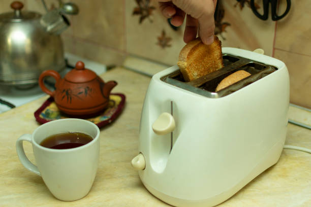 istock making breakfast toast bread with toaster at home kitchen 1198215245