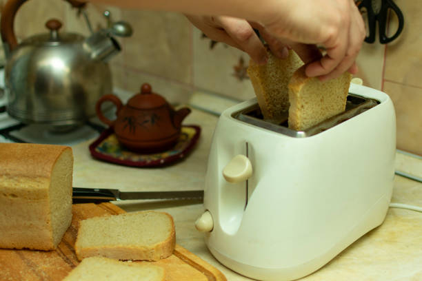 istock making breakfast toast bread with toaster at home kitchen 1198215253