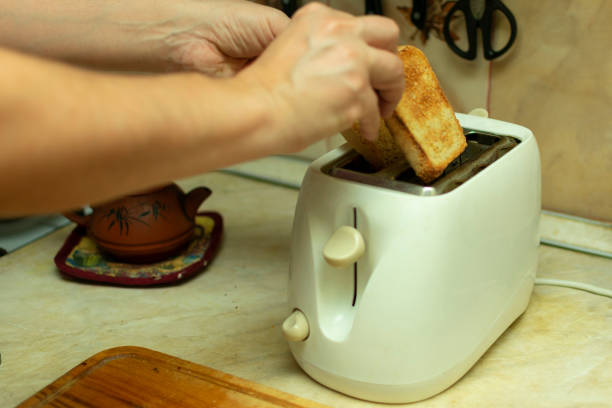 istock making breakfast toast bread with toaster at home kitchen 1198215262