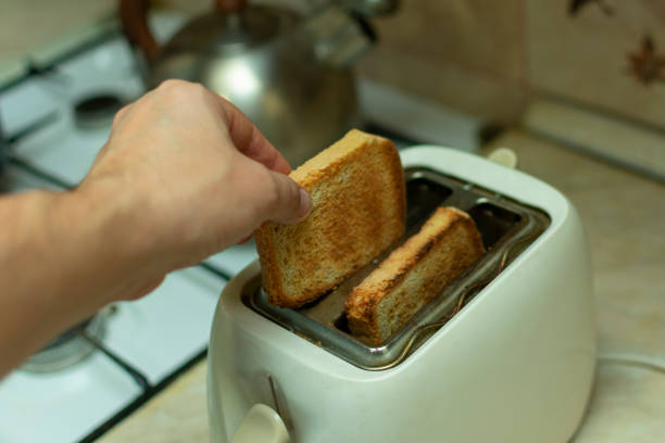 istock making breakfast toast bread with toaster at home kitchen 1198215263