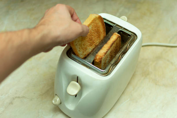 istock making breakfast toast bread with toaster at home kitchen 1198215269