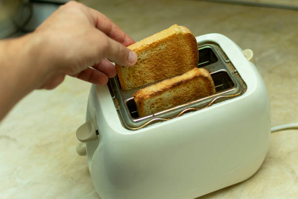 istock making breakfast toast bread with toaster at home kitchen 1198215270