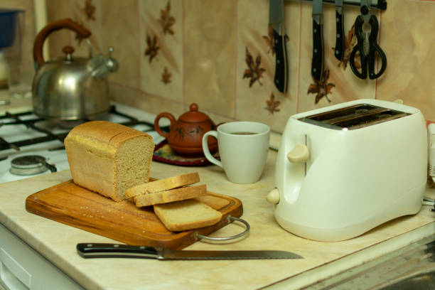 istock making breakfast toast bread with toaster at home kitchen 1198215315