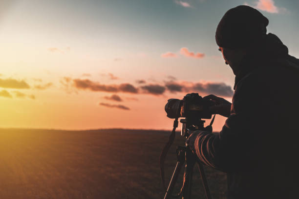 istock photographer with tripod and camera 1198216480