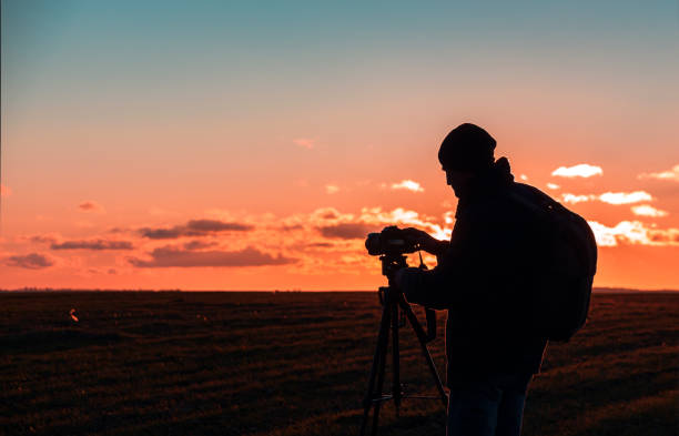 istock photographer with tripod and camera 1198216496