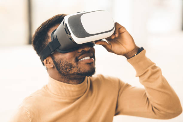 istock Afro manager wearing augmented reality goggles at office 1198216753