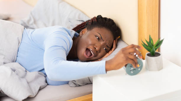 istock Girl Having A Hard Time Waking Up Lying In Bed 1198217727