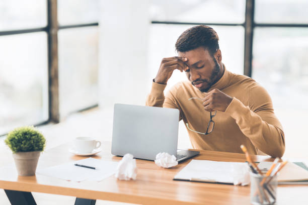 istock Frustrated black businessman taking off glasses massaging nose 1198217829