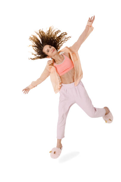 istock Young attractive woman having fun jumping on a white 1198218700