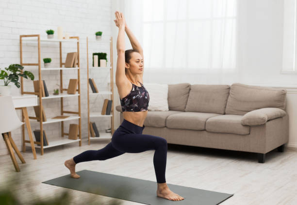 istock Athletic woman doing yoga, stretching exercise at home 1198218811