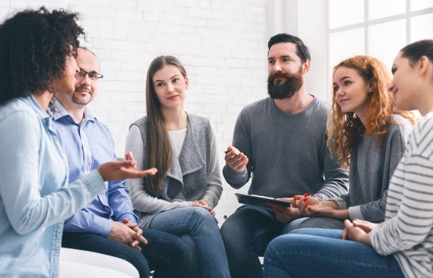istock Specialist giving advices to patients during group therapy 1198218889