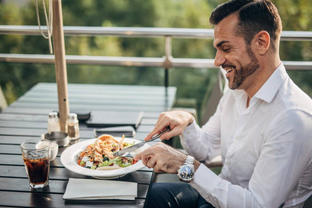 istock Gentleman eating lunch alone outdoors in restaurant 1198219036