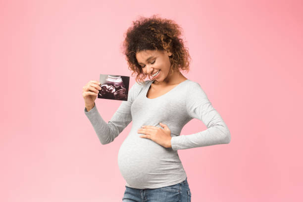 istock First sonography. Future mother holding ultrasound scan 1198219074