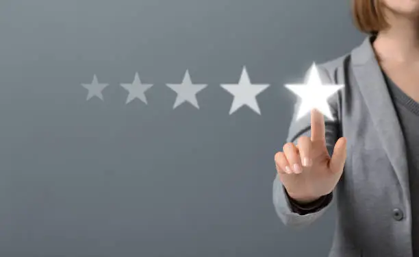 Photo of Hand of Client pressing Five Star Excellent survey Rating