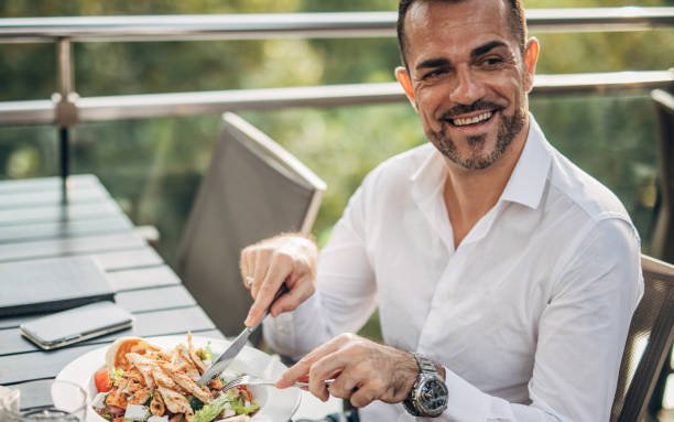 istock Gentleman eating lunch alone outdoors in restaurant 1198219199
