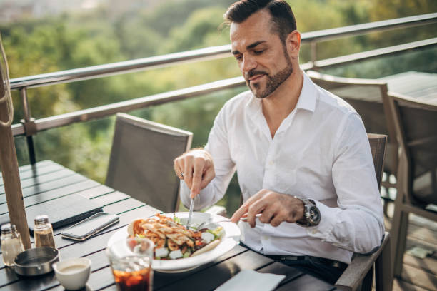 istock Gentleman eating lunch alone outdoors in restaurant 1198219771