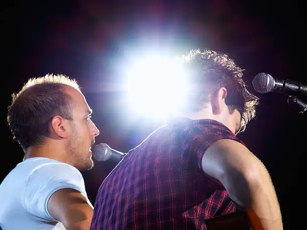 Photo of Back view of musicians with a halo light effect