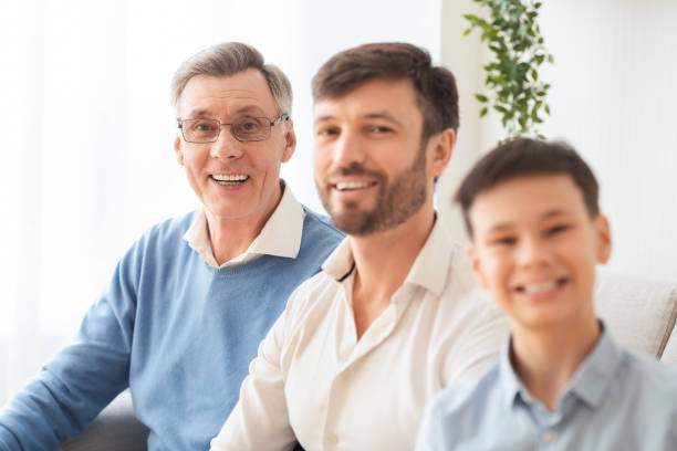 istock Senior Man, Son And Grandson Sitting On Sofa At Home 1198220991