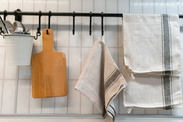 a kitchen towel and utensils are hanging on the wall. scandinavian cuisine - pano da cozinha imagens e fotografias de stock