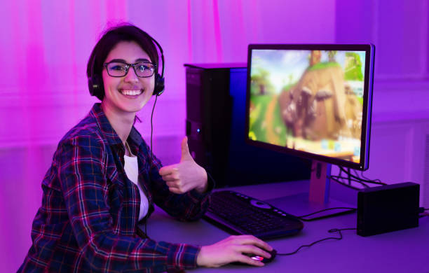 istock Addicted female gamer showing thumb up, playing game 1198222452
