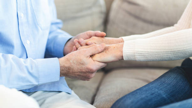 istock Unrecognizable elderly couple holding hands at home 1198222729