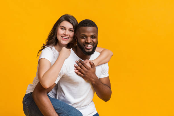 istock Afro guy giving piggyback ride to his girlfriend 1198222762