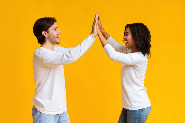 istock Joyful Interracial Couple Giving High Five To Each Other 1198222927