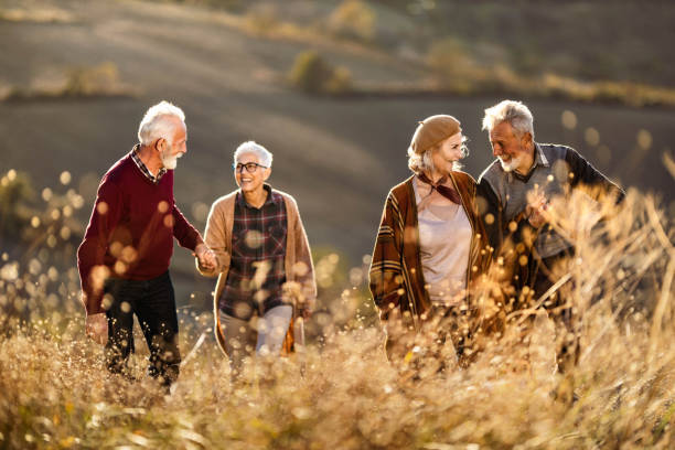 istock Happy mature couples talking while walking on the hill in autumn day. 1198223863