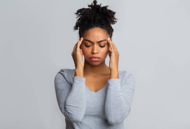 istock Upset black woman having headache, massaging her temples 1198224653