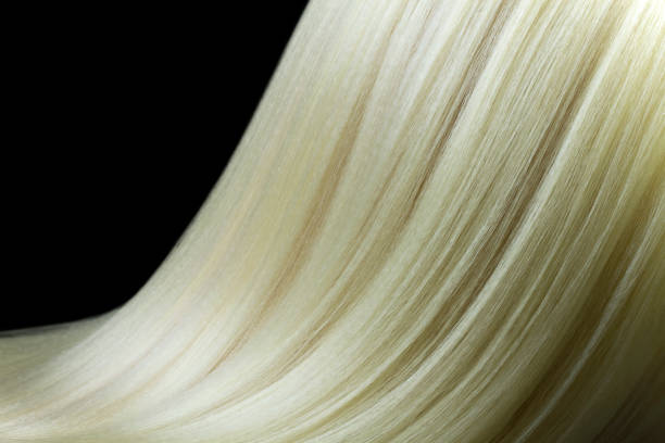 istock Close-up blond hair texture on black background 1198225440