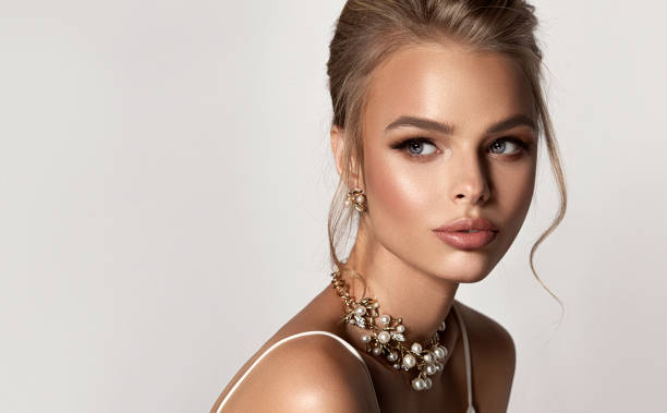 portrait of beautifully looking young blonde haired woman in elegant jewellery set. beauty, hairstyling  and cosmetic. - hair bun hairstyle beautiful looking imagens e fotografias de stock