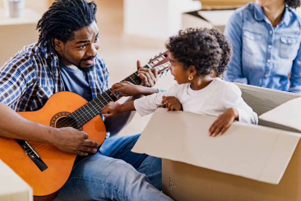 istock Playing guitar while relocating in new apartment! 1198226024