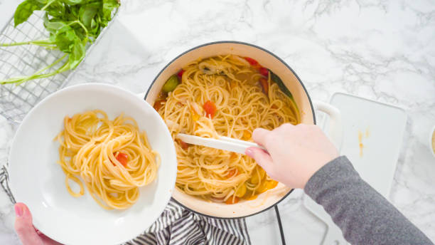 istock Serving a one-pot pasta into a white pasta plate. 1198226046