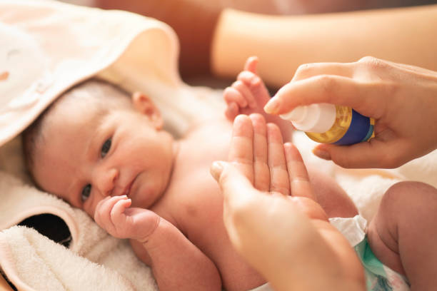 istock Mother makes massage with baby oil 1198226729