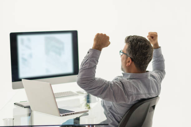 Happy architect celebrating in office