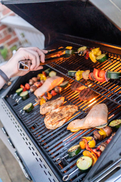 istock Grilling an Atlantic salmon, chicken breast, vegetable skewers 1198227804