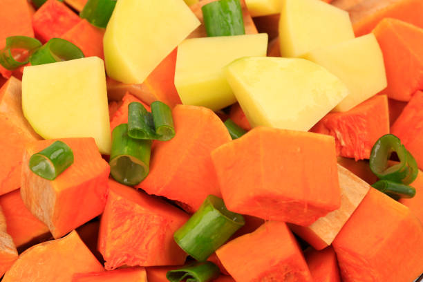 istock Freshly cut vegetables pumpkin, potato isolated on white background 1198228124
