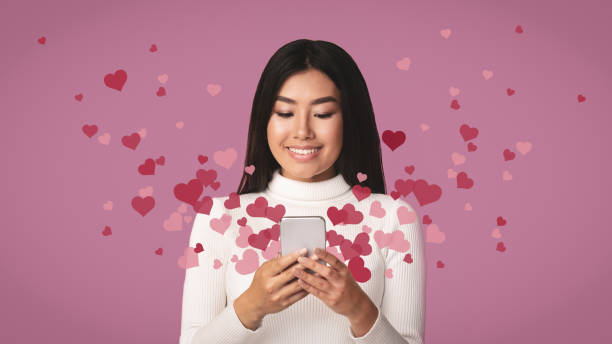 istock Love mail. Hearts flying out from smartphone 1198228274