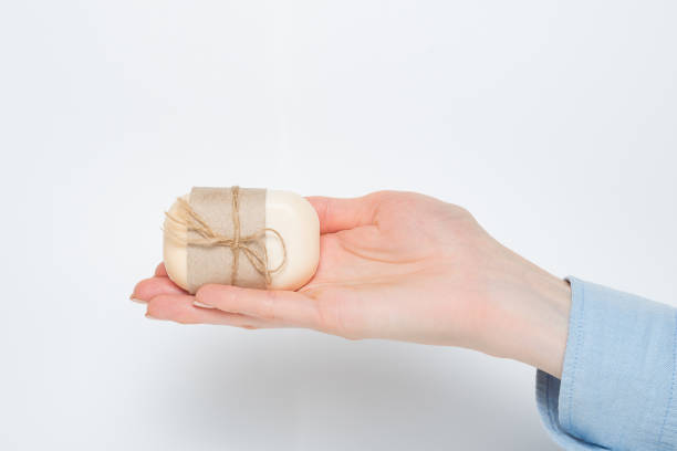 istock Handmade soap on a female palm. Isolated on white background 1198229639